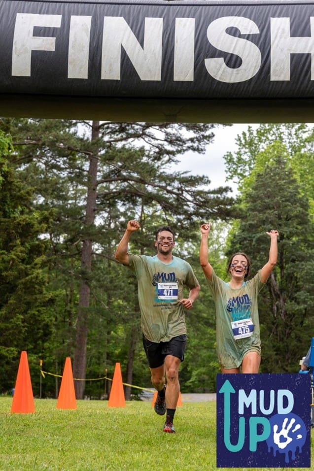 Two runners cross a finish line